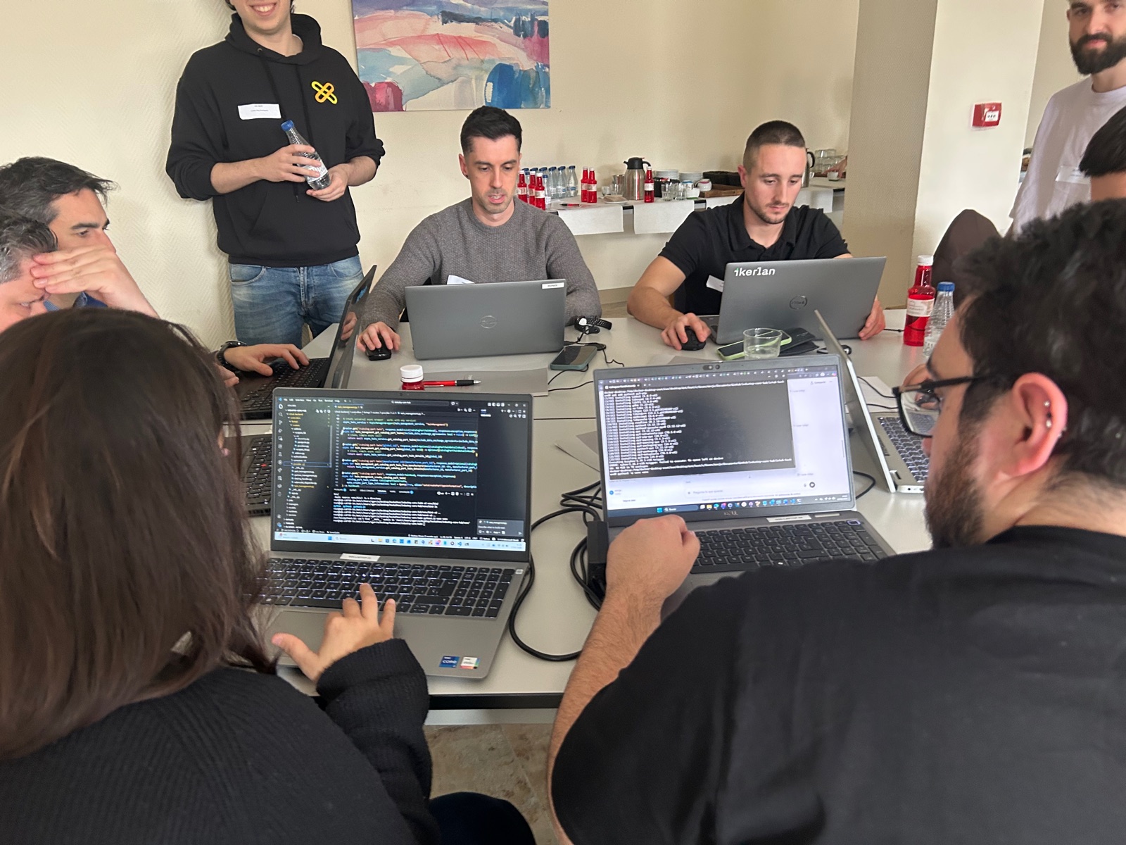 Participants coding on their laptops with terminals and editors open